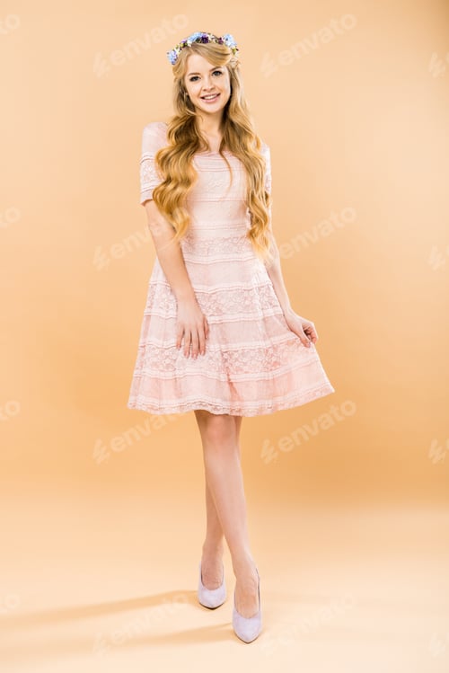 Preview: beautiful woman in delicate lacy dress and colorful floral wreath on yellow background