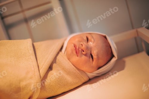 Preview: A newborn baby wrapped up after birth lies on the table
