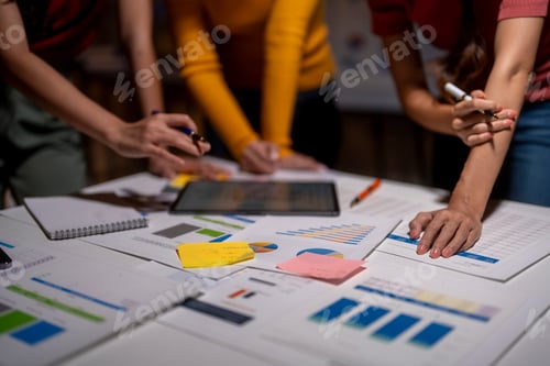 Preview: Business team working late, analyzing financial data and brainstorming new ideas