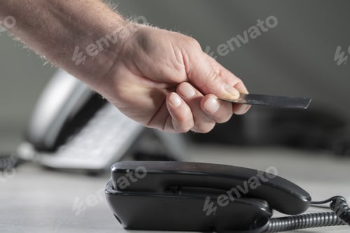 Preview: Male hand giving a credit card to a shop worker