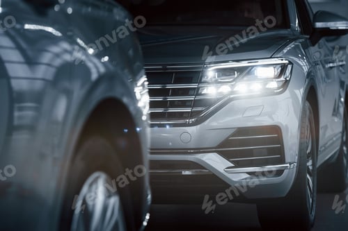 Preview: Modern technology. Particle view of modern luxury cars parked indoors at daytime