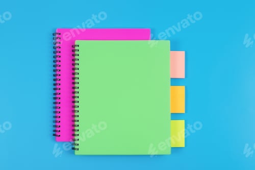 Preview: Top view of colourful notebooks and sticky notes on blue table background.