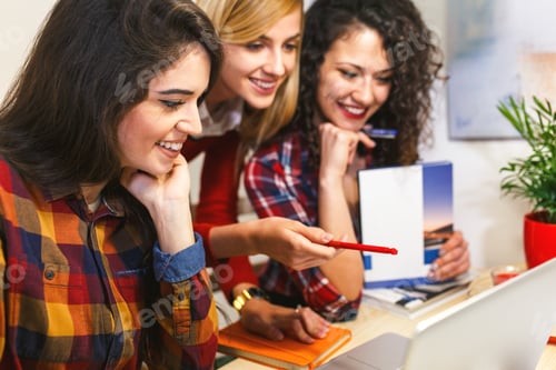 Preview: Three young female students study together at home.