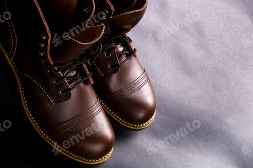 Preview: Fashionable mens leather brown shoes on black background.