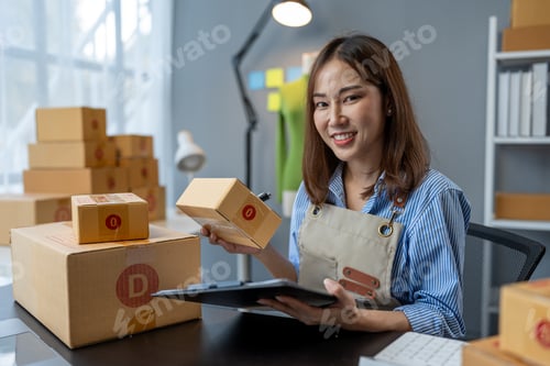 Preview: Small business start-up, SME owner, female entrepreneur working on packaging parcels. Receipt and ch