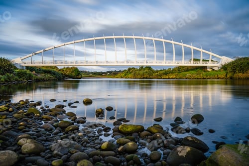 Preview: Beautiful view of the Te Rewa Rewa Bridge under a cloudy blue sky in New Plymouth, New Zealand