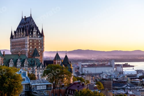 Preview: Beautiful view of the Chateau Frontenac surrounded by greenery in Quebec, Canada at sunrise