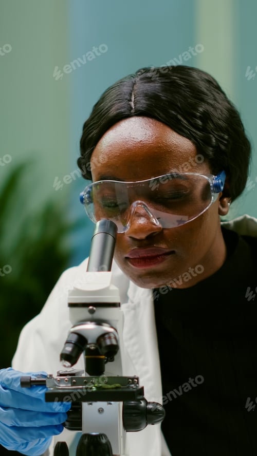 Preview: Portrait of scientist taking leaf sample with micropipette putting on slide