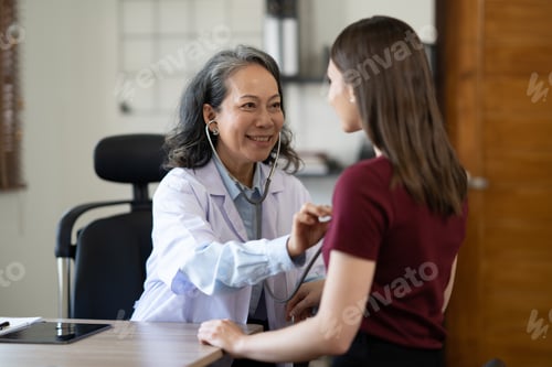 Preview: Professonal famale checking young woman heart rate. Medical care concept.