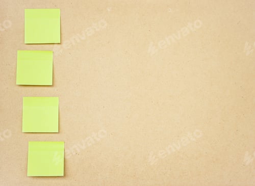 Preview: Green sticky note on brown clipboard or plywood board background