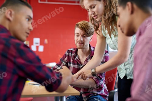 Preview: Unposed group of creative business people in an open concept office brainstorming.