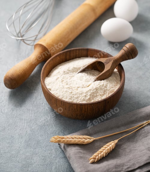 Preview: Ingredients for baking, flour, eggs, rolling pin and kitchen textiles on a blue background.