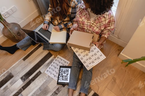 Preview: two multiracial women small business owners working from home - freelancers doing shipping -