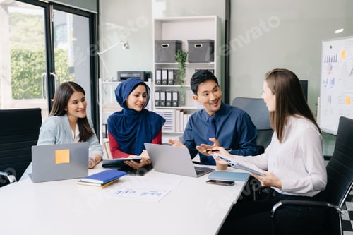 Preview: Multiracial group of young creative people in smart casual wear discussing business brainstorming
