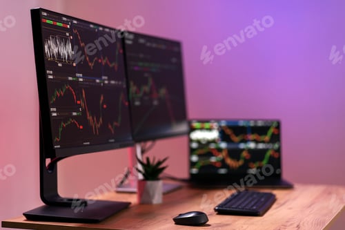 Preview: Financial Charts Displayed on Computer Screens at Workplace