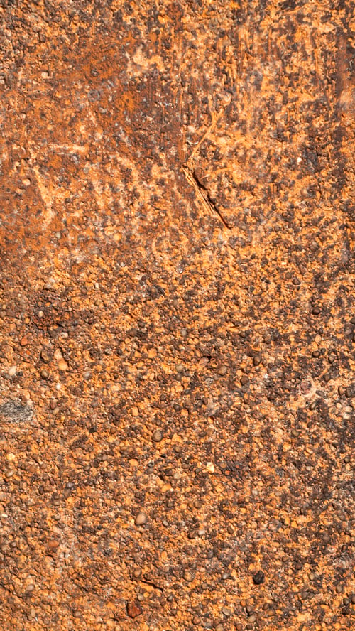 Vorschau: Makrofoto eines orangefarbenen Ziegels mit sichtbarer Textur. Hintergrund