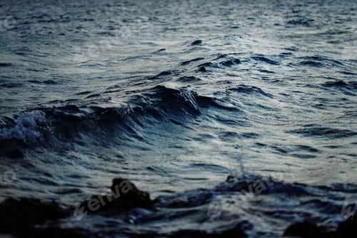 Preview: Dark deep blue sea water with waves in twilight