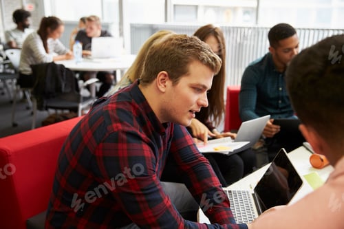 Preview: Group Of Students In Library Collaborating On Project