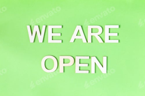 Preview: We are open quote, welcome sign for business or caffe, wooden letters on green background