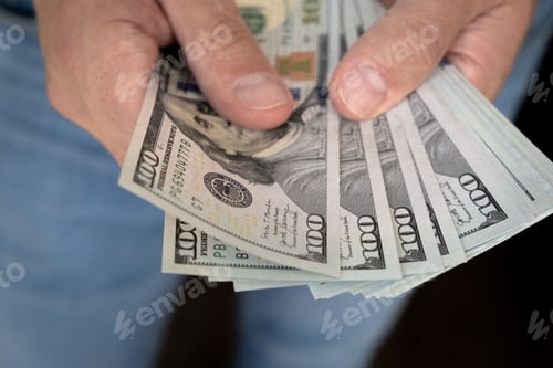 Preview: Close up male hand Counting and holding money us dollar.