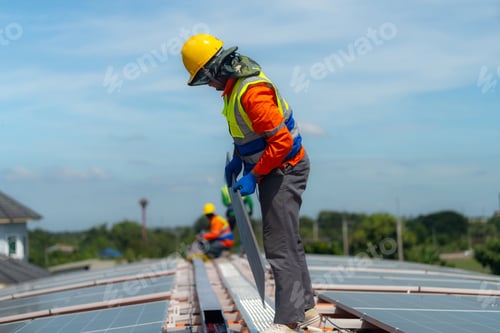 Preview: Worker Technicians are working to construct solar panels system on roof.