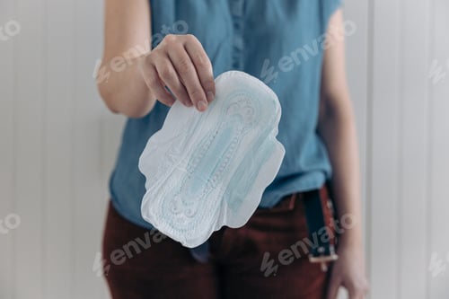 Preview: Woman holds a menstrual pad