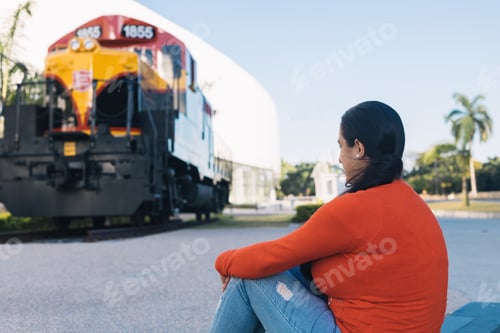 Preview: woman sitting looking at the relic railway, thinking about the stories.