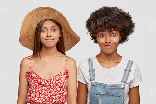 Preview: People, diversity and facial expressions concept. Surprised impressed two females keep lips pressed,
