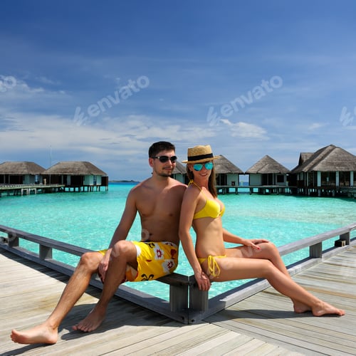 Preview: Couple On A Tropical Beach Jetty At Maldives