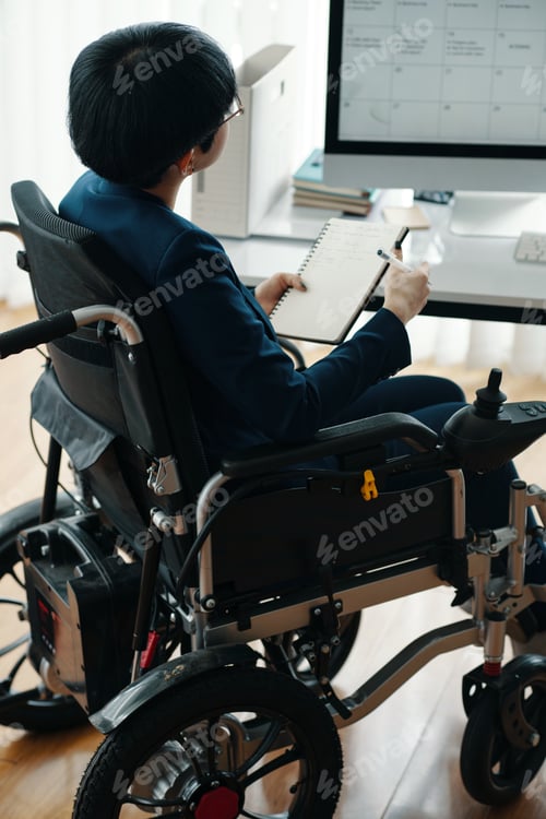 Preview: Businesswoman With Disability Making Timetable