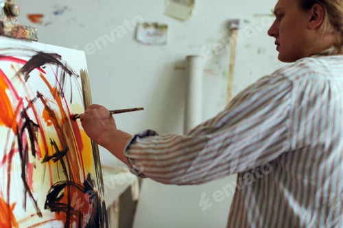 Preview: Creative male artist drawing picture oil paints