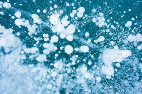 Preview: Natural ice bubbles on frozen lake in wintertime