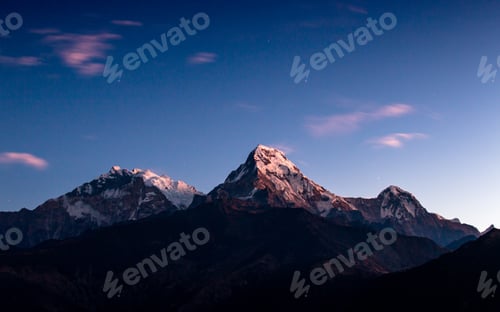 Preview: Snow Capped Mountains at Sunset with Cloudy Skies