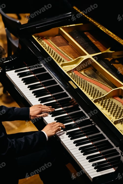 Preview: Hands of classical pianist playing his piano during a concert.