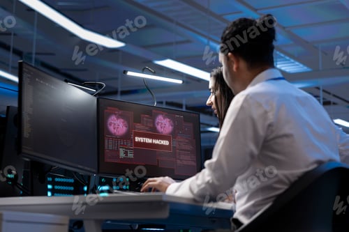 Preview: IT staff members in high tech facility trying to protect servers from hacker