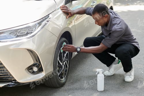 Preview: Car Owner Cleaning Alloy Rim