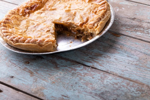 Preview: Baked sliced stuffed pie in plate on wooden table