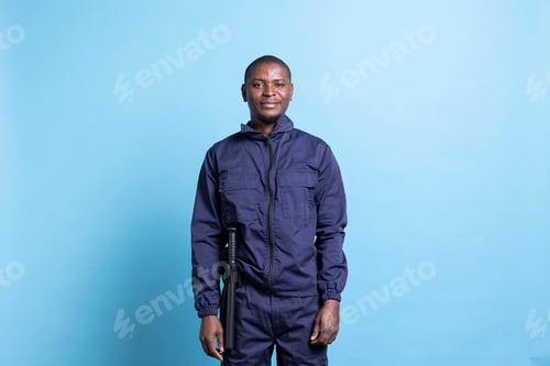 Preview: Portrait of african american security agent in uniform with baton
