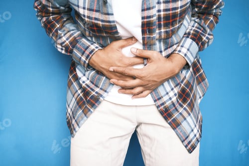 Preview: young man suffering stomach pain close up.