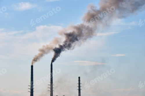 Preview: Closeup of thermal power plant high pipes with black smoke moving upwards polluting atmosphere