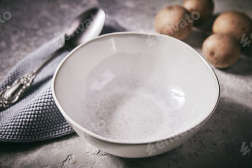 Preview: Closeup shot of a white bowl and spoon near