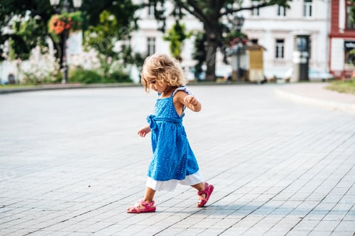 Preview: Beautiful little girl walking in the sun