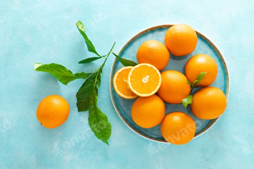 Preview: Oranges with leaves on blue background, top view