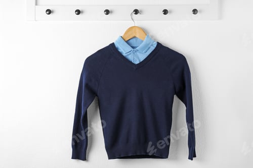 Preview: Shirt and jumper on hanger indoors. School uniform