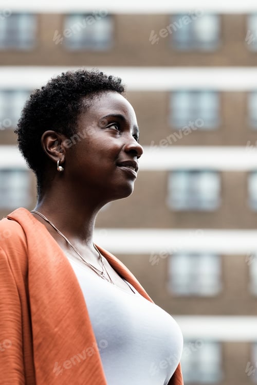Preview: Proud black woman looking confident outside.