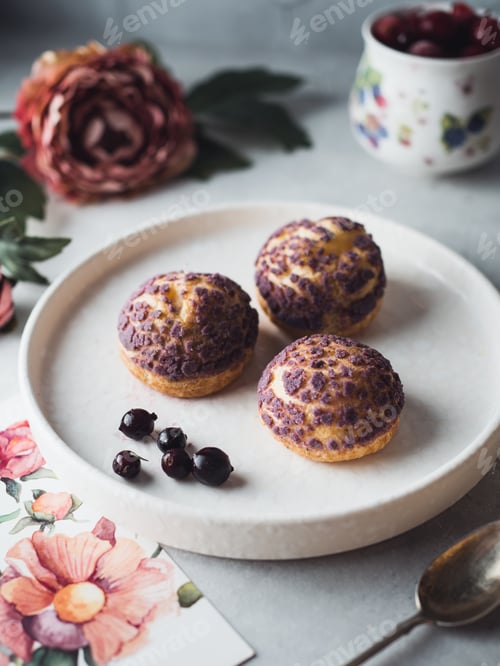 Preview: Delicate purple cream puffs on white plate