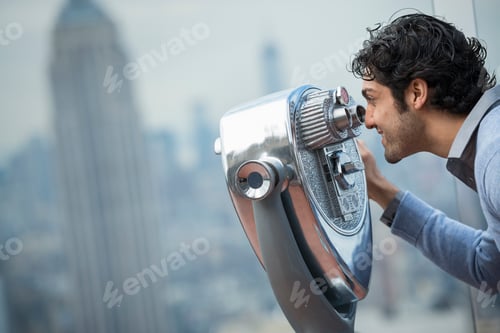 Preview: An observation deck overlooking the Empire State Building. A young man looking through a telescope.