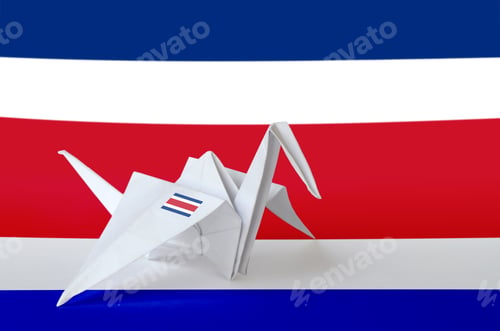 Preview: Costa Rica flag depicted on paper origami crane wing. Oriental handmade arts concept