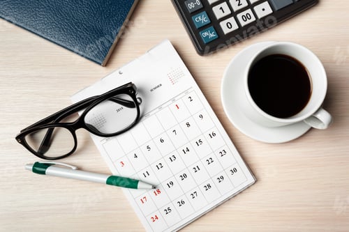 Preview: Working from home setup with a calendar, coffee, and office supplies in an organized space