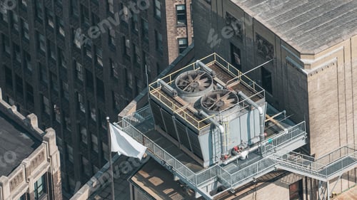Preview: A large industrial building with a large cooling tower on top